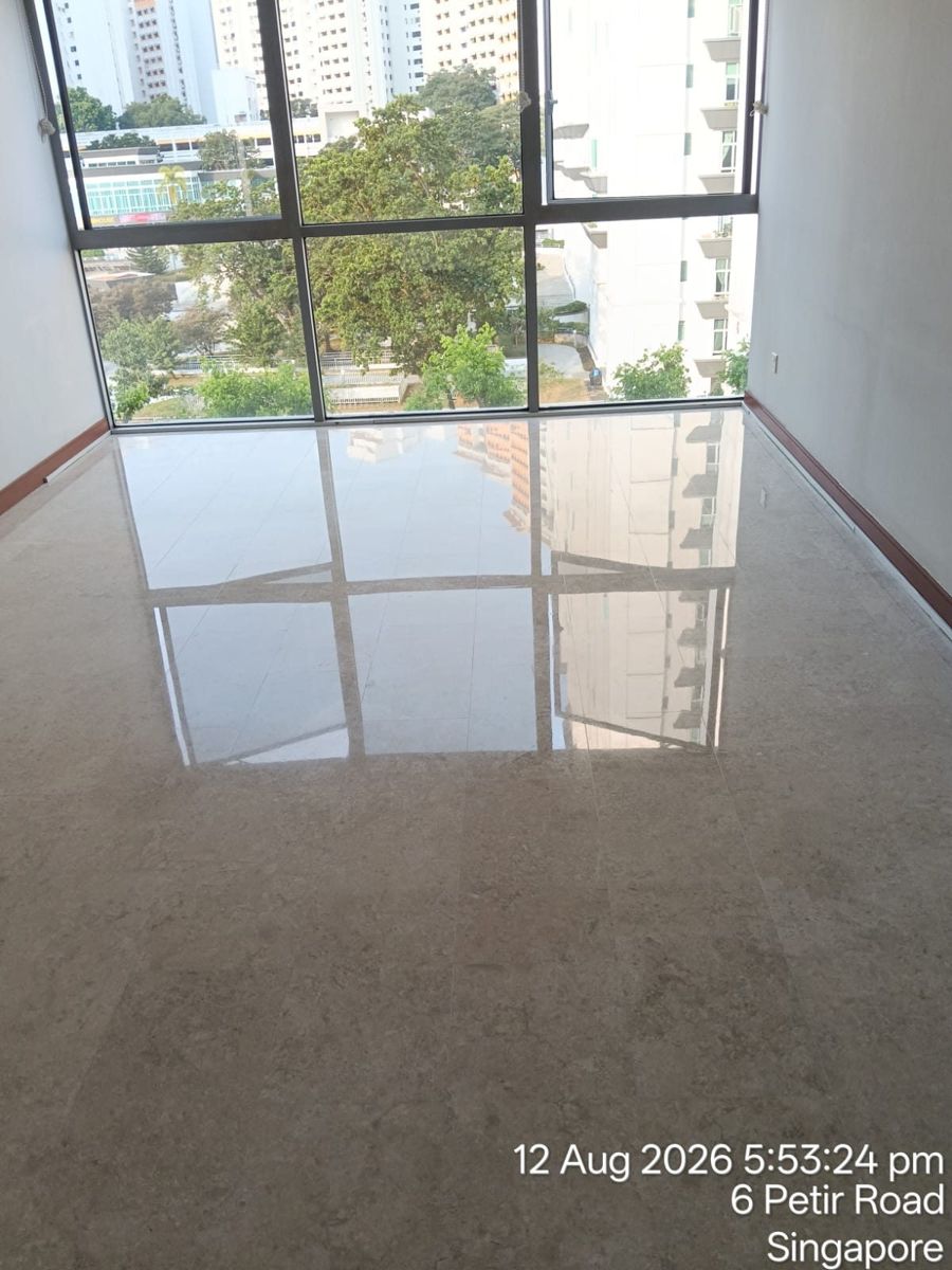 Beige marble floor reflecting tall windows after polishing