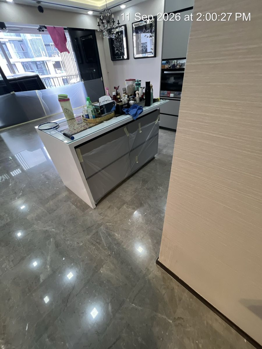 Grey marble floor around a kitchen island after polishing