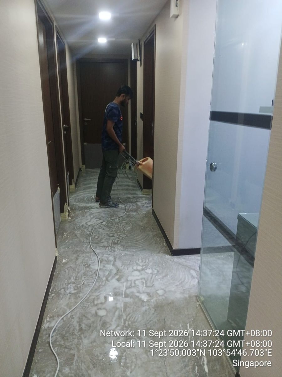 Technician honing marble in a bedroom corridor