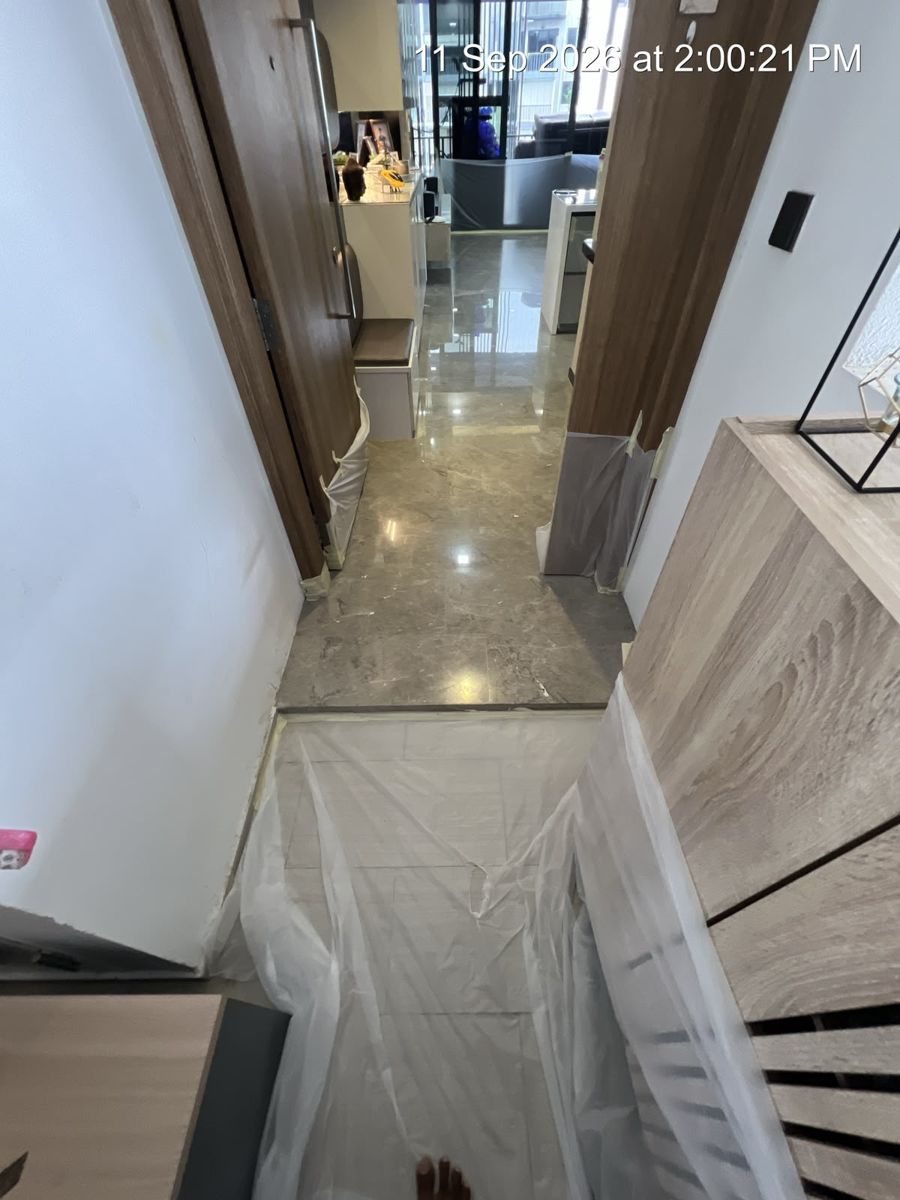 Plastic protection taped over cabinets during marble polishing